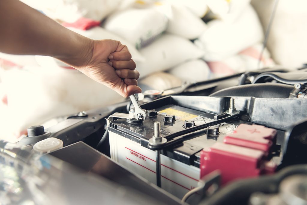 Tightening a Cadillac vehicle battery during routine maintenance